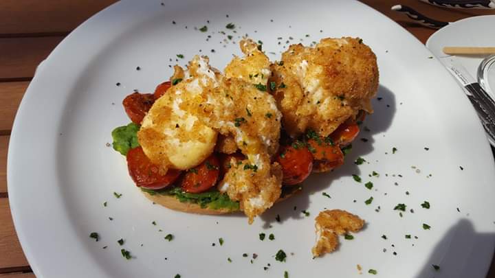 A golden-topped dish served on a white plate